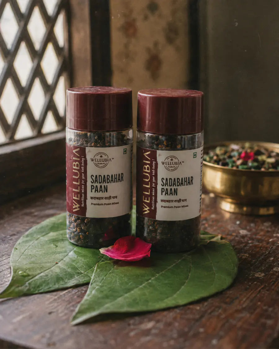 Two bottles of Wellubia Sadabahar Paan mukhwas on a betel leaf